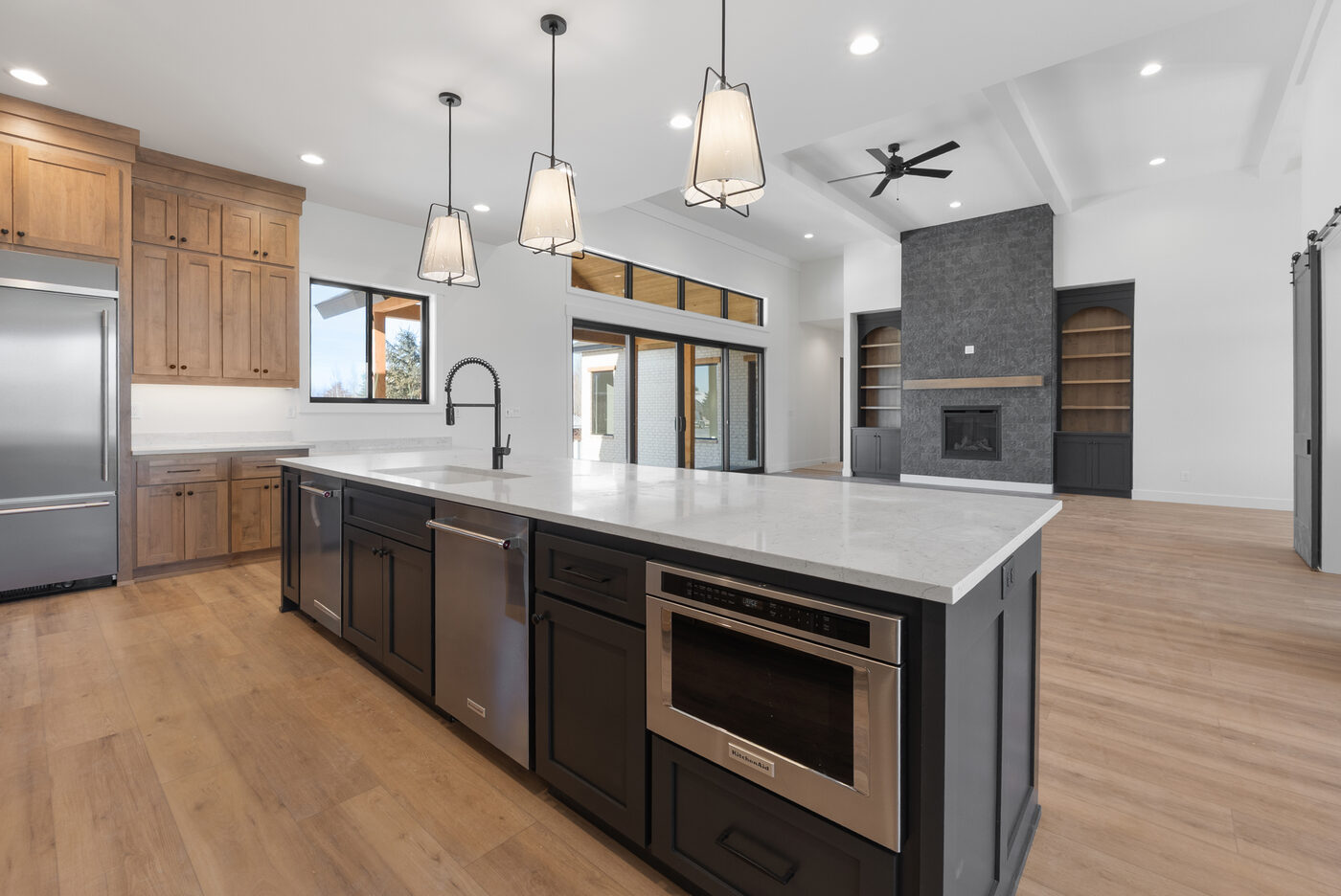 Gourmet kitchen with massive island, dual dishwashers, KitchenAid appliances, and quartz countertops at 560 Partridge Lane Rexburg Idaho